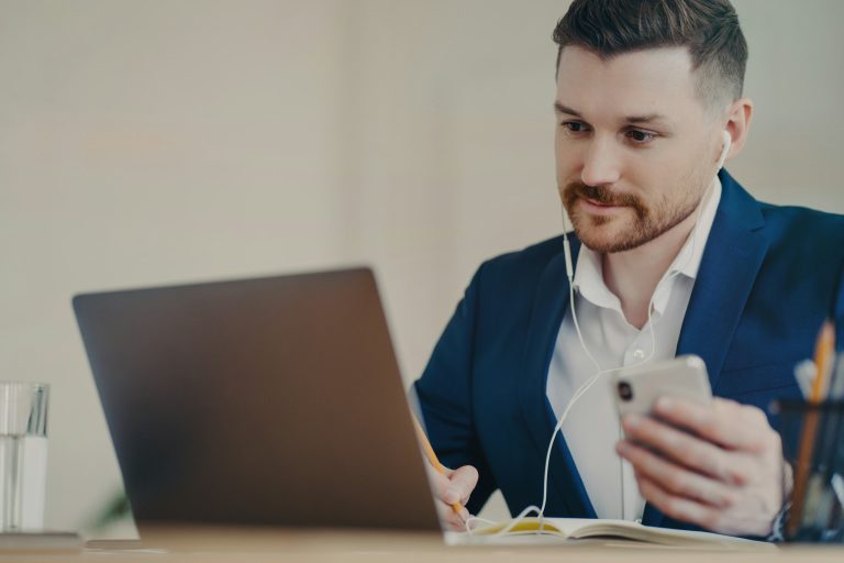 Concentrated businessman having video call on laptop in modern office